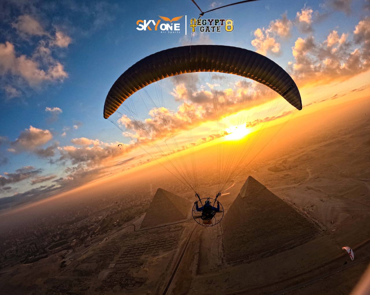 Paramotor flying over the Pyramids of Giza at sunset